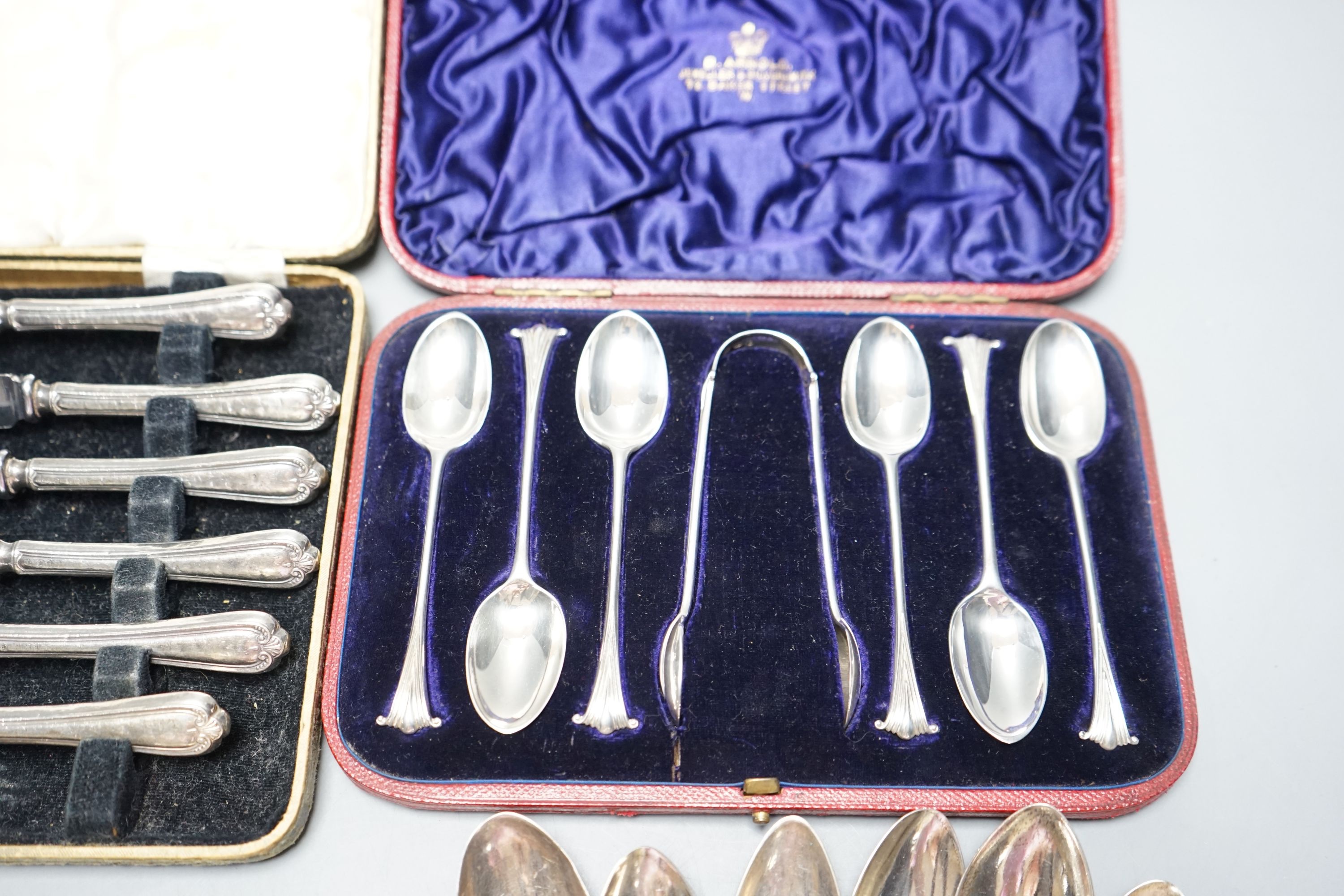 Two George III silver 'berry' spoons, seven other silver spoons, pair of silver tongs, a Swedish white metal teaspoons and two cased sets including silver teaspoons.